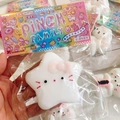 Soft white star cat squishy stress toy with pink bow decoration in blind bag packaging - Hello Kitty Large Star