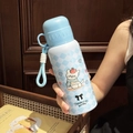 Detail of insulated water bottle featuring cute puppy pattern and portable carry strap - 600ml / Blue (Plaid & Puppy Print)