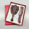 Detail of vintage peacock makeup mirror and comb set in a red textured gift box - Butterfly / Red Copper