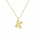 Detailed close-up of shiny 18k gold plated letter K bubble pendant necklace on a thin chain - Necklace K