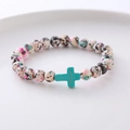 Close-up of beaded bracelet with multi-color spotted beads and turquoise cross pendant - Black Pink Cyan Spotted Turquoise Cross