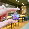 Macro detail of a purple star resin pendant with glitter and heart-shaped sequins inside - No Keychain / Purple