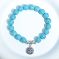 Blue turquoise bead bracelet with silver Lucky flower pendant on white tray - Blue Turquoise LUCKY Tag Charm