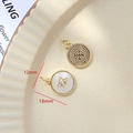 Macro shot of 12mm gold-plated shell pendant with diamond cross on ceramic plate - 7# Round X-Shape Zirconia MOP Pendant