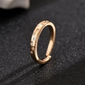 Golden hollow star ring with sparkling crystal inlay on a dark textured surface - Gold