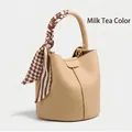 Chic milk tea bucket bag in lychee leather with a decorative plaid scarf on the handle - Milk Tea
