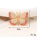 Detailed view of 4cm gold butterfly charm with red and white rhinestones on beige background - D1200-Bright Red Butterfly