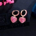 Macro shot of rose gold heart earrings with pink zircon stones on a black jewelry box - Rose Red