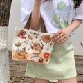 Beige Capybara cartoon canvas handbag with brown straps shown in outdoor setting - Happy Capybara-Beige
