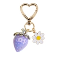 Close-up of cute purple strawberry and white daisy charms with a gold heart clasp - Purple Strawberry White Daisy