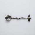 Detailed view of dragonfly handle design and hammered texture on metal dessert spoon - Gunmetal