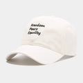 Close-up of cream baseball cap featuring triple letter embroidery and curved brim - M (56-58cm) / White