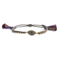 Detail of colorful woven Evil Eye bracelet with gold beads and silk tassels on white background - Colorful Bead Chain Tassel