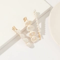 Detailed view of three golden hairpins with white pearls and natural shells on white decor - White Shell Pearl 3-Piece Side Clip Set