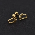 Detailed view of tiny gold baby feet stud earrings with screw ball back closure - Footprint / Gold