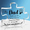 Macro shot of puzzle-shaped clear acrylic ornament with Dad Father's Day print - Dad Fist Bump Style (Q15)
