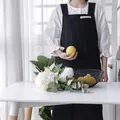 Minimalist black cotton linen apron featuring H-shaped wide straps and decorative label - Black