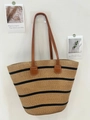 Retro straw woven tote bag with black stripes and brown leather straps on a white wall - Brown Black Wide Stripe