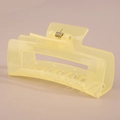 Detail view of a rectangular matte light yellow hair claw with a visible metal spring - Bulk Packaging / #22 Glossy Jelly Yellow