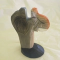Carved grey wooden animal eyeglass holder on black circular stand decorative sculpture - Elephant