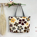 Close-up of stylish canvas tote bag with brown flower prints hanging on a wooden wall hook - Beige Khaki Flowers