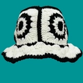 Handcrafted black and white knit bucket hat with floral pattern on green background - One Size / White Black Five Flowers Hat