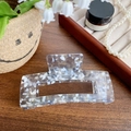 Grey marble acetate hair claw clip with rectangular cutout on a rustic wood surface - Shimmering Blue 13cm
