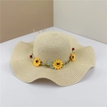Wide brim wavy straw sun hat with sunflower garland for beach vacations and summer sun protection - Adult M / Beige