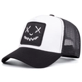 Detail of street style trucker hat showing embroidered cross-eye smiley face patch - Adjustable / Black and White