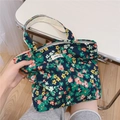 Close-up of floral cotton tote bag with white handles and a simple wish woven label - Small Green Flower