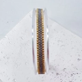 Macro detail of handmade woven Miyuki seed bead texture in gold and grey tones - Dark Gray