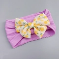 Detail of purple nylon headband featuring a yellow floral print bow for infants - Violet