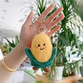 Detailed view of plush corn keychain with yellow grain texture and green leaf accents - Corn Style with Gold Clasp