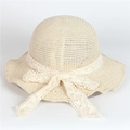 Detailed macro view of the delicate beige straw weave and lace bow on a sun hat - Beige