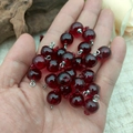 Deep red resin fruit sphere charms with silver loops shown in hand for scale - Transparent Red Whole Pomegranate Silver Pin