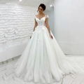 Elegant off-shoulder white bridal gown with lace floral appliqués and long tulle train - US 26W / White