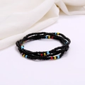 Detailed close-up of multi-layer handmade colorful glass seed bead waist chains on white fabric - #31(Black Red Yellow Blue)