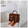Detail of a brown glossy mini jelly crossbody bag with double magnetic gold buckles - Coffee