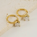 Detailed macro shot of 18K gold-plated earrings with square cubic zirconia pendants - Square Style (ZYG335) / White
