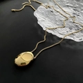 Elegant gold long necklace with pebble pendant on minimalist dark glass background - Long Oval Chain (02-J21 Gold)