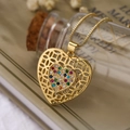 Minimalist gold hollow heart necklace with colorful gemstone pendant on a vintage background - Gold Multicolored Zirconia
