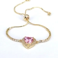 Detailed macro view of pink heart zircon bracelet with adjustable gold box chain - Pink