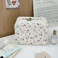 Detail of white PU leather cosmetic case with Hello Kitty prints and top handle grip - White Bear Cat