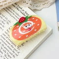 Cartoon cake roll hair claw clip in yellow and orange on a vintage book background - Strawberry Tart