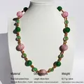Pink and green handmade glass bead necklace on white mannequin with gold-plated brass - Handmade Lampwork Mid-length Necklace / Green Pink Mix