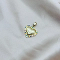 Dettaglio macro del ciondolo a cuore dorato con zirconi colorati e trama a raggi - Stile Cuore Radioso Gemma Colorata