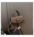 Detail of a brown PU leather trapezoid handbag featuring a textured golden D-buckle closure - Dark Brown