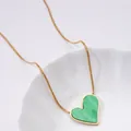 Detail of heart pendant necklace with green stone inlay on elegant gold snake chain - Green Heart