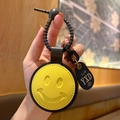 Gele smiley leren sleutelhanger met zwarte gevlochten band en life-label - Leer-Geel Glimlach