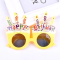 Detail of yellow birthday cake party glasses with colorful candles and Happy Birthday text - Cake Candle Yellow